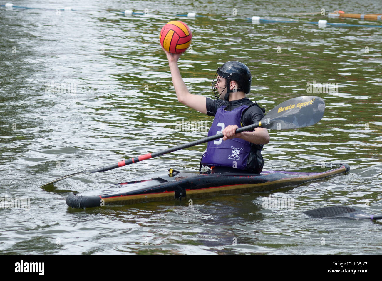 Participants in a canoe water polo match competing to win on the River