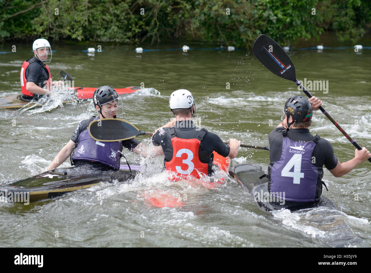 Participants in a canoe water polo match competing to win on the River
