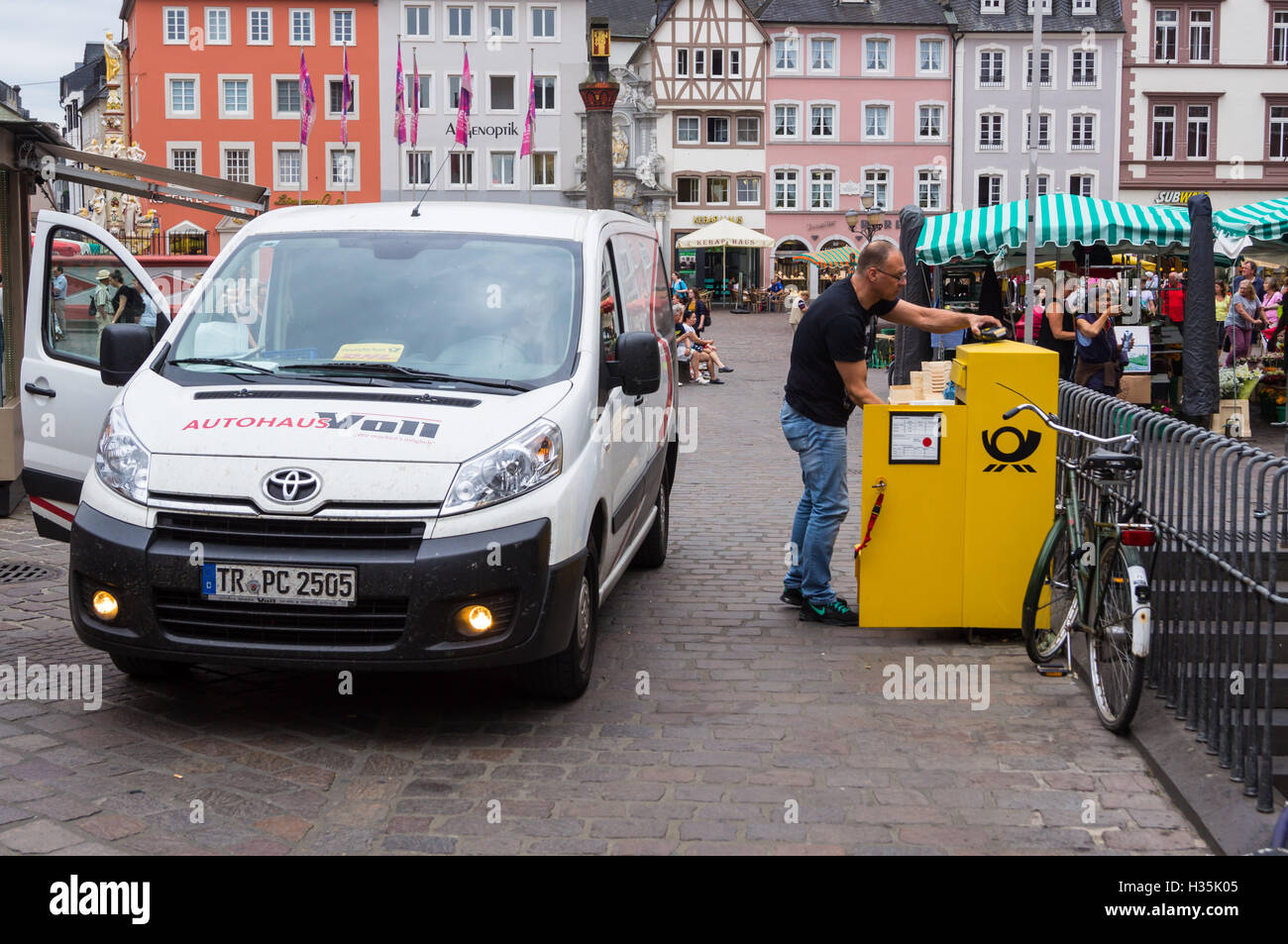 A contractor in a hired Toyota van collecting Deutsche Post mail, Hauptmarkt, market place, Trier, Rheinland-Pfalz, Germany -Trèves Stock Photo
