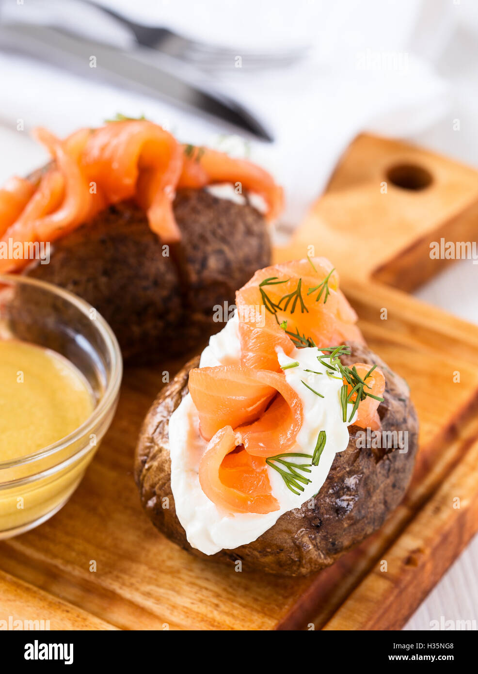 Crispy jacket potatoes with light soft cheese, smoked salmon fillet and