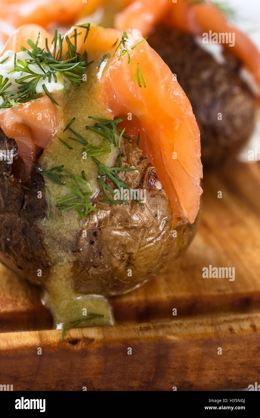 Crispy jacket potatoes with light soft cheese, smoked salmon fillet and