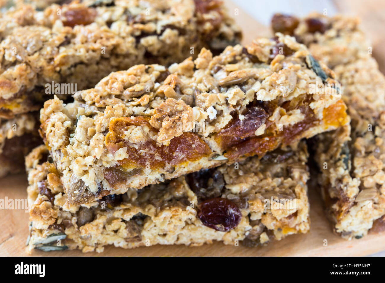 Healthy homemade granola bars and various ingredients on background