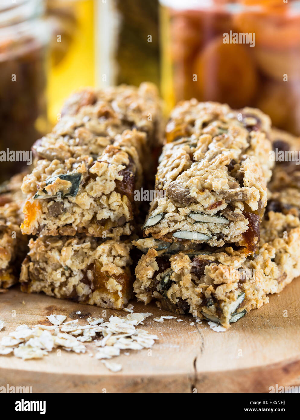 Healthy homemade granola bars and various ingredients on background