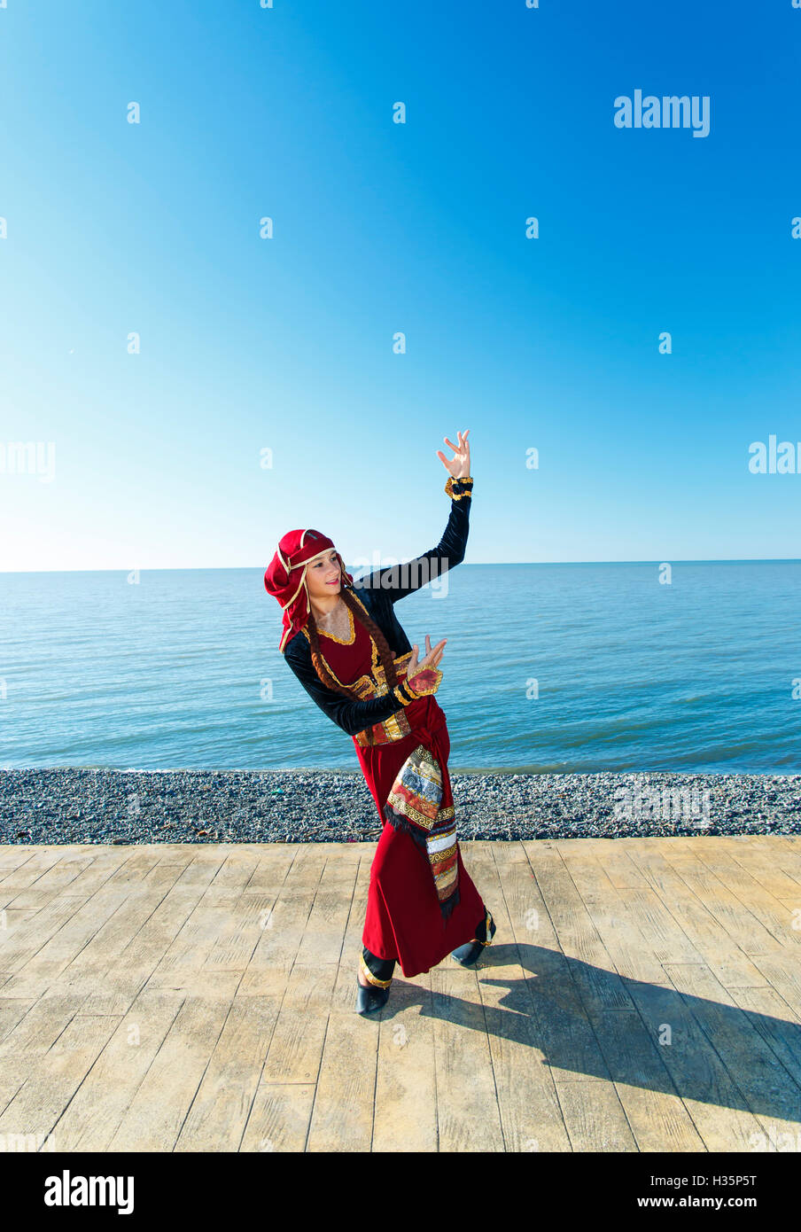 woman dancing georgian national clothes sea outdoors Stock Photo