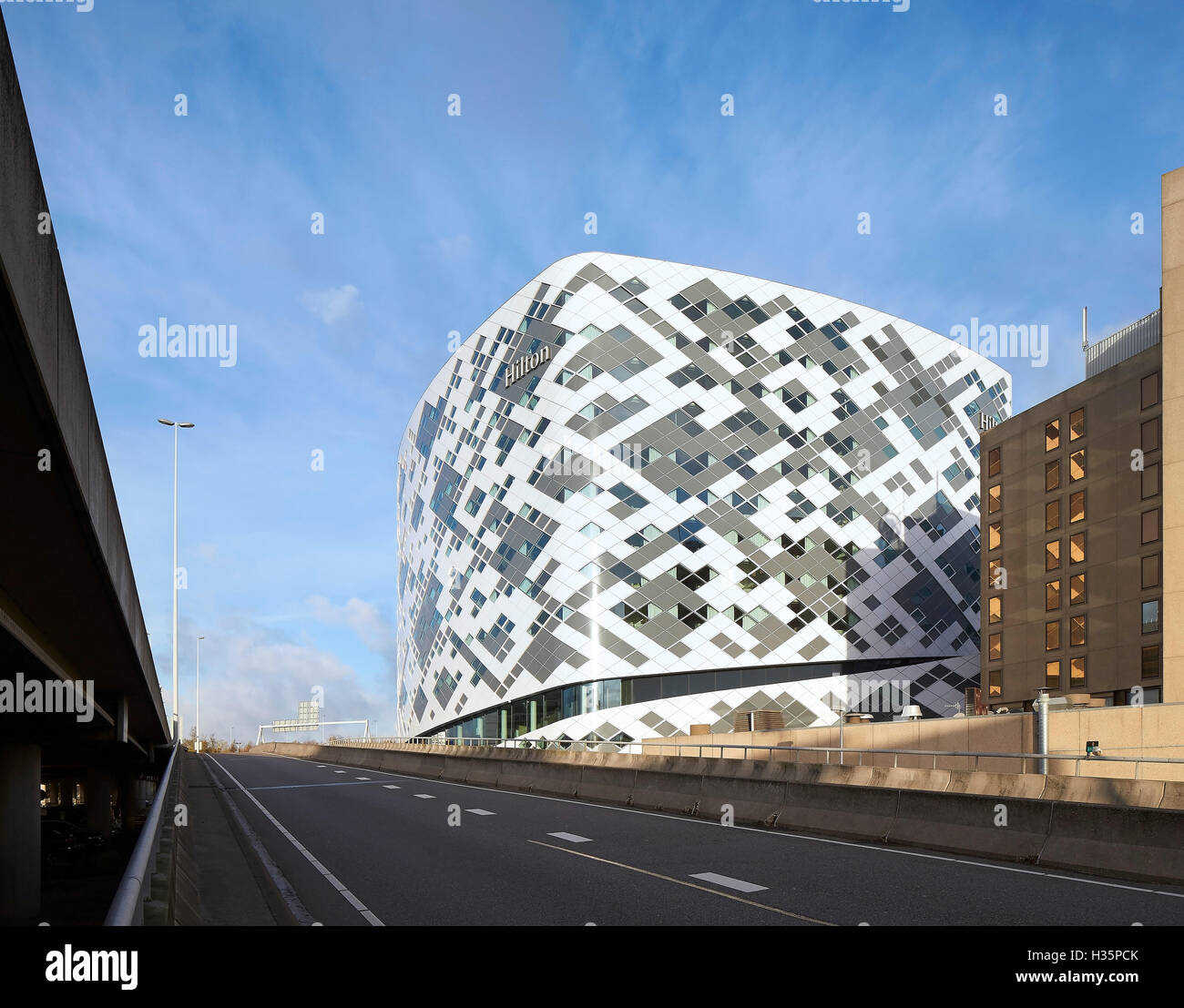 Diagonal pattern of exterior facade as seen from street. Hilton Amsterdam Airport Schiphol, Amsterdam, Netherlands. Architect: Mecanoo Architects, 2015. Stock Photo