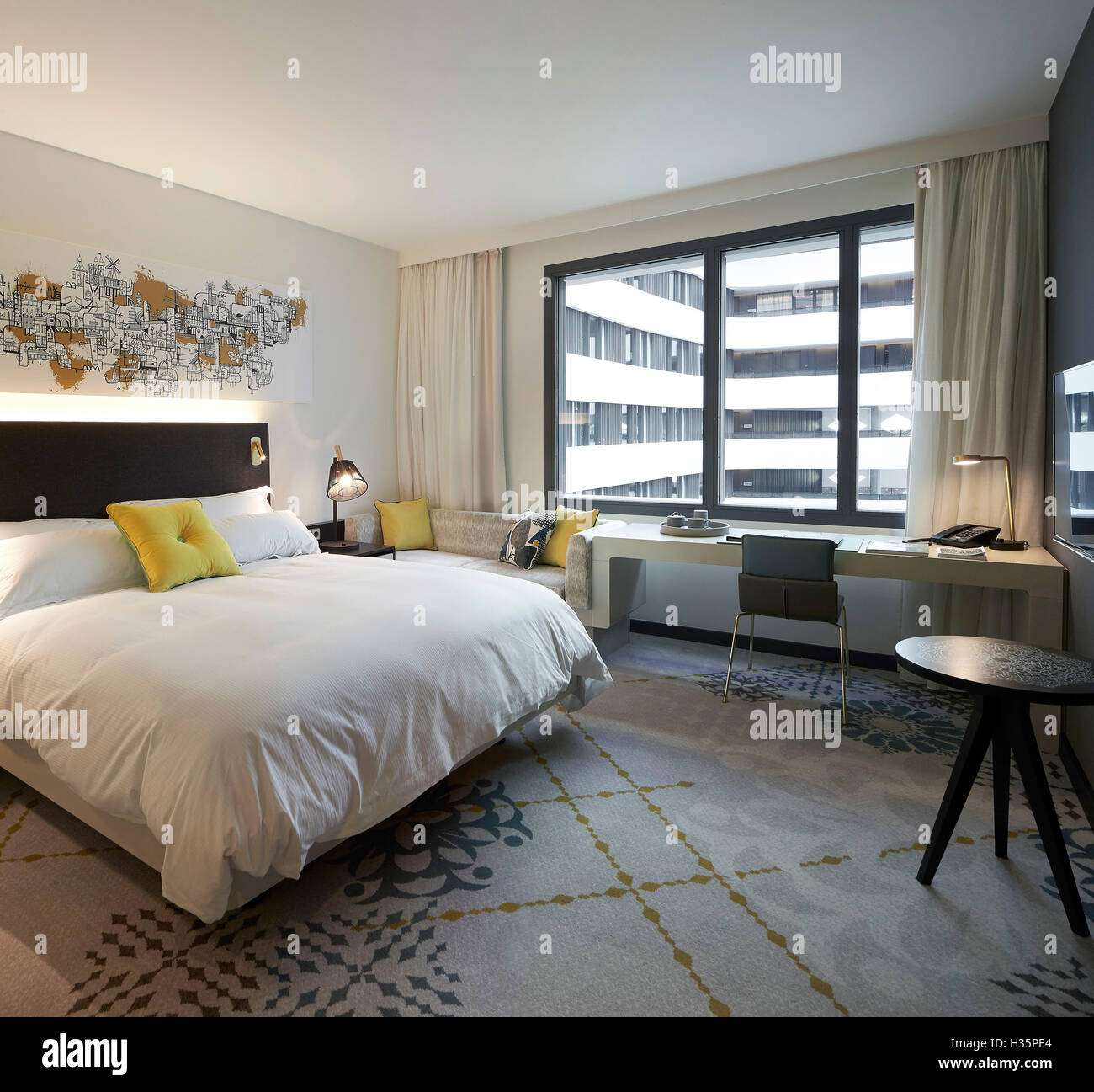 Bedroom with view to atrium. Hilton Amsterdam Airport Schiphol, Amsterdam, Netherlands. Architect: Mecanoo Architects, 2015. Stock Photo