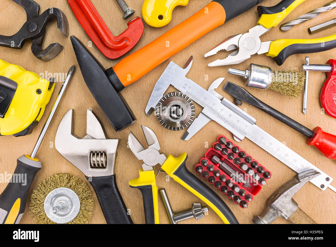 Set of assorted working tools on wooden background Stock Photo - Alamy