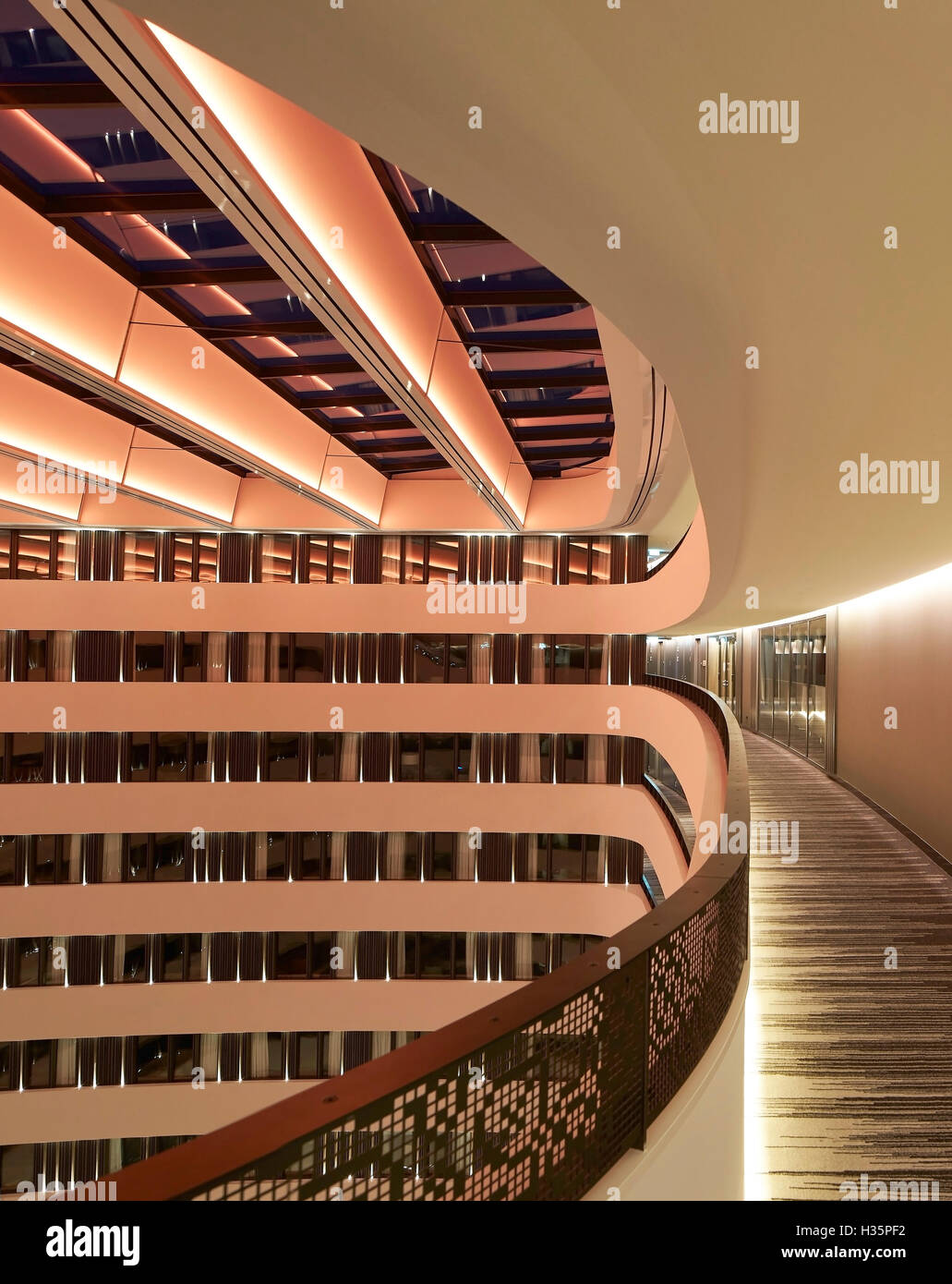 Upper floor corridor. Hilton Amsterdam Airport Schiphol, Amsterdam, Netherlands. Architect: Mecanoo Architects, 2015. Stock Photo