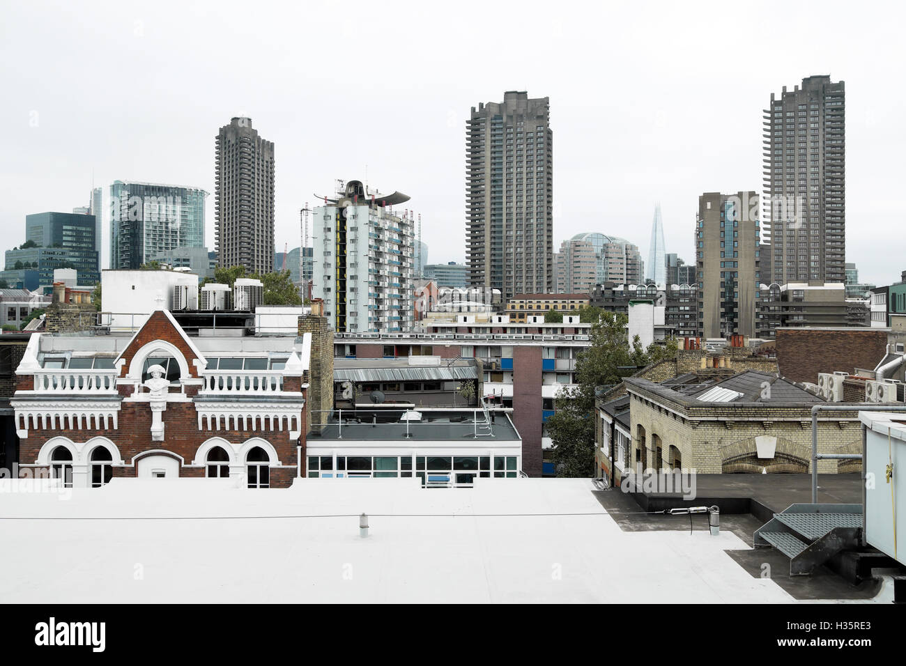 London skyline view of Barbican Estate towers & contrasting new old  buildings from rooftop on Old Street East London UK   KATHY DEWITT Stock Photo