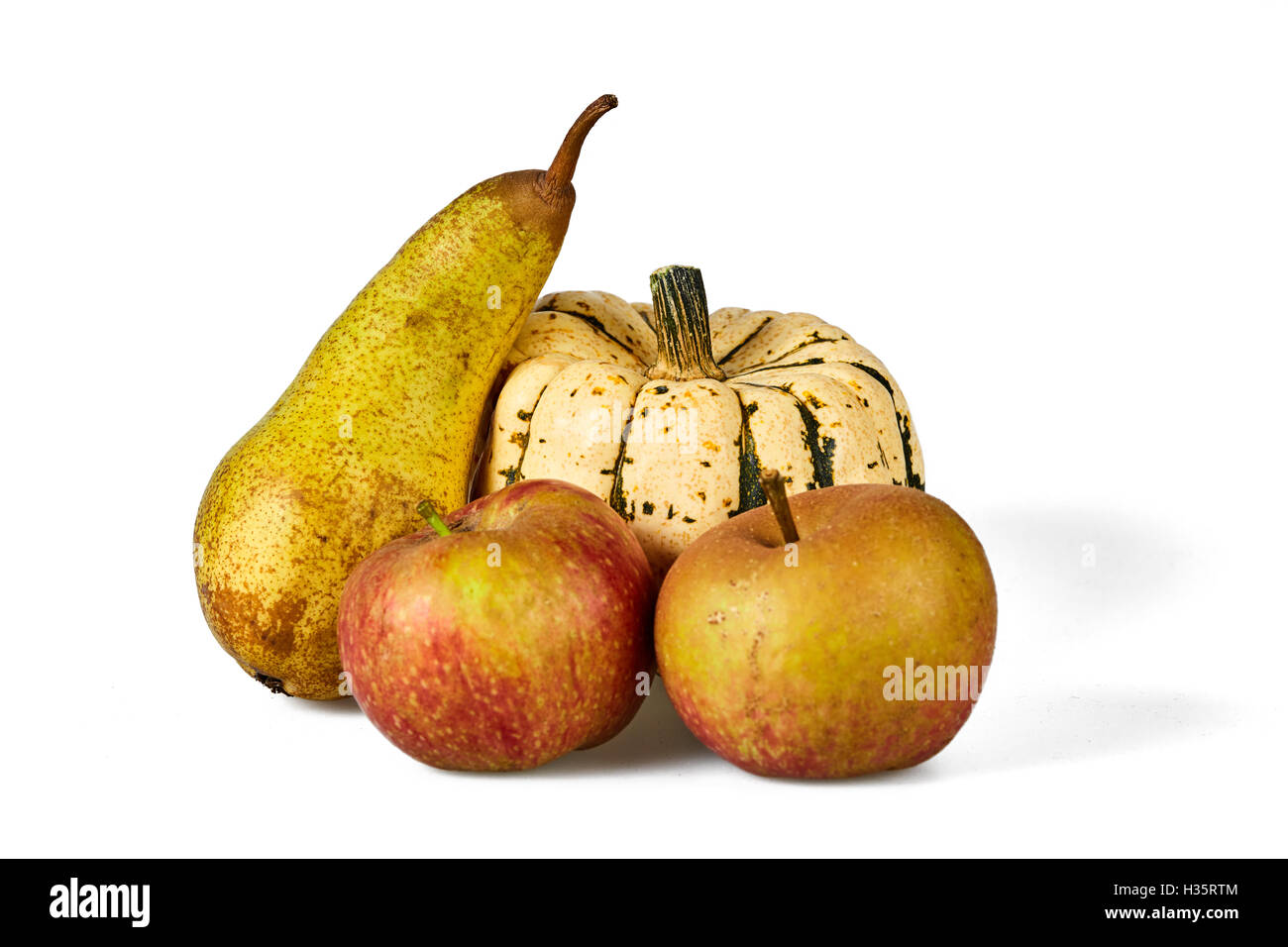 Isolated apple, pear and pumpkin autumn seasonal fruits Stock Photo