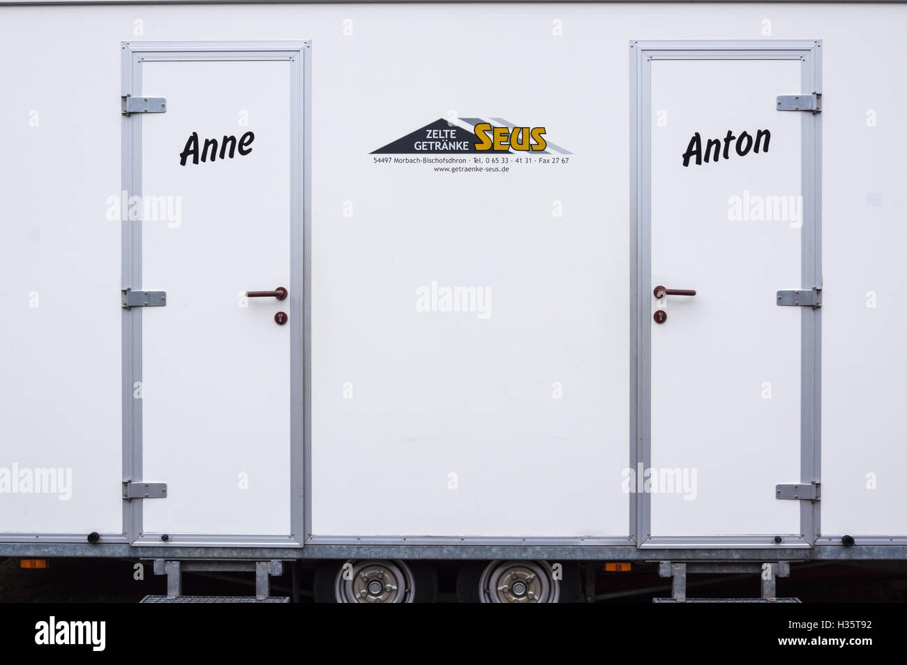 Anne and Anton denoting ladies' and gents' cubicles on a portable public toilet, Wolf, Mosel, Nordrhein-Westfalen, Germany Stock Photo