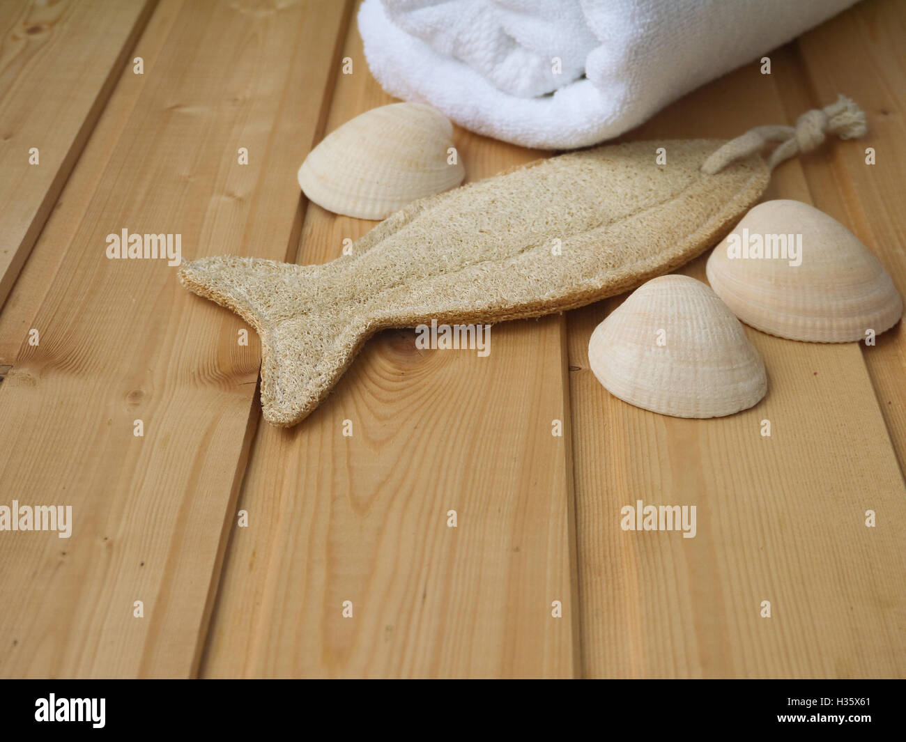 Towel,shells and luffa wisp on the wooden background Stock Photo