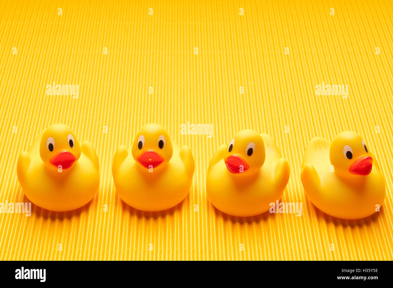 four yellow toy rubber ducks Stock Photo - Alamy