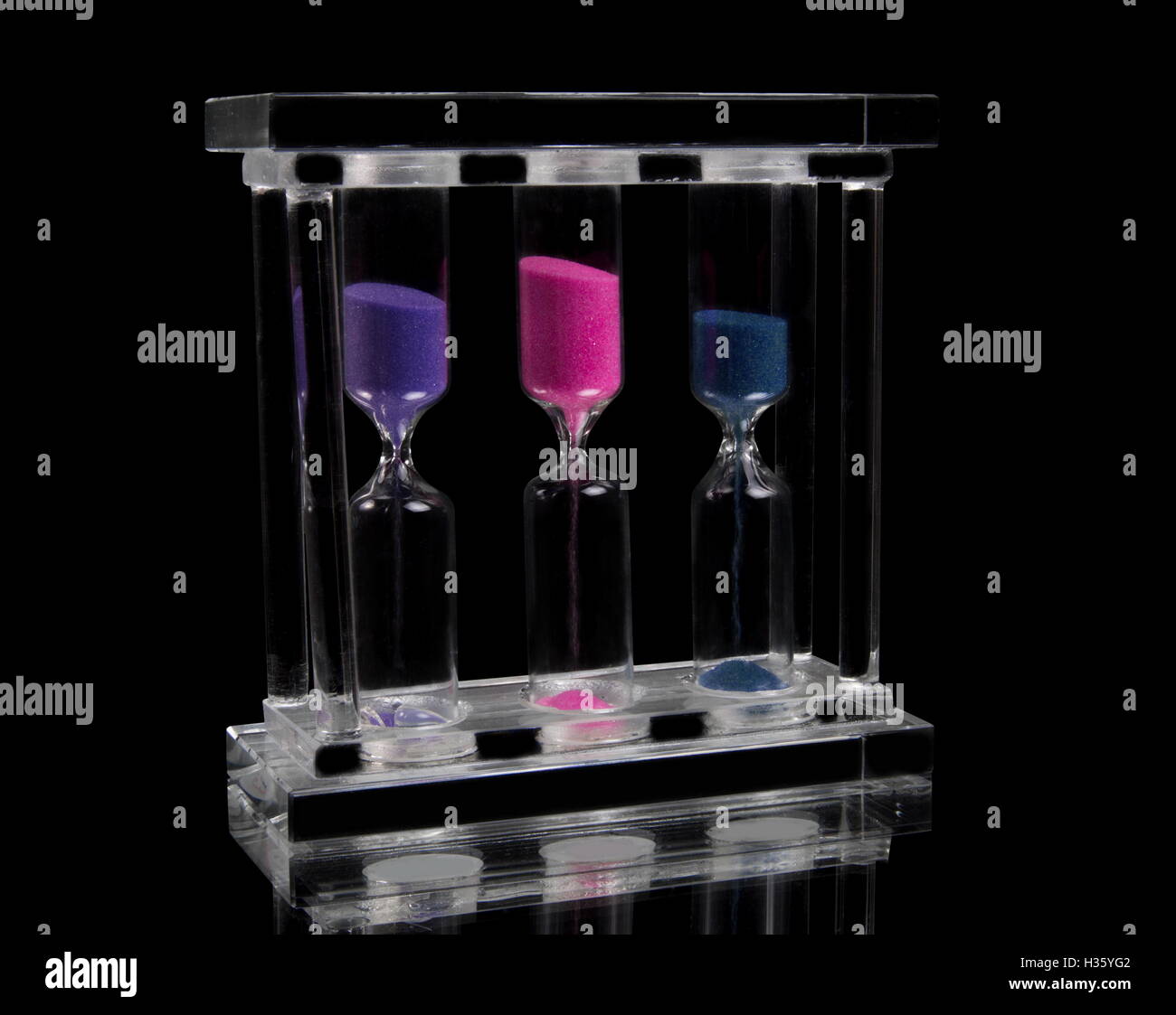 sand clock on black background Stock Photo - Alamy