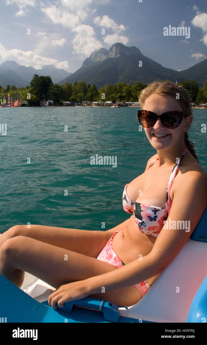 Young girl enjoying a pedalo ride on a lake in the French Alps. Stock Photo