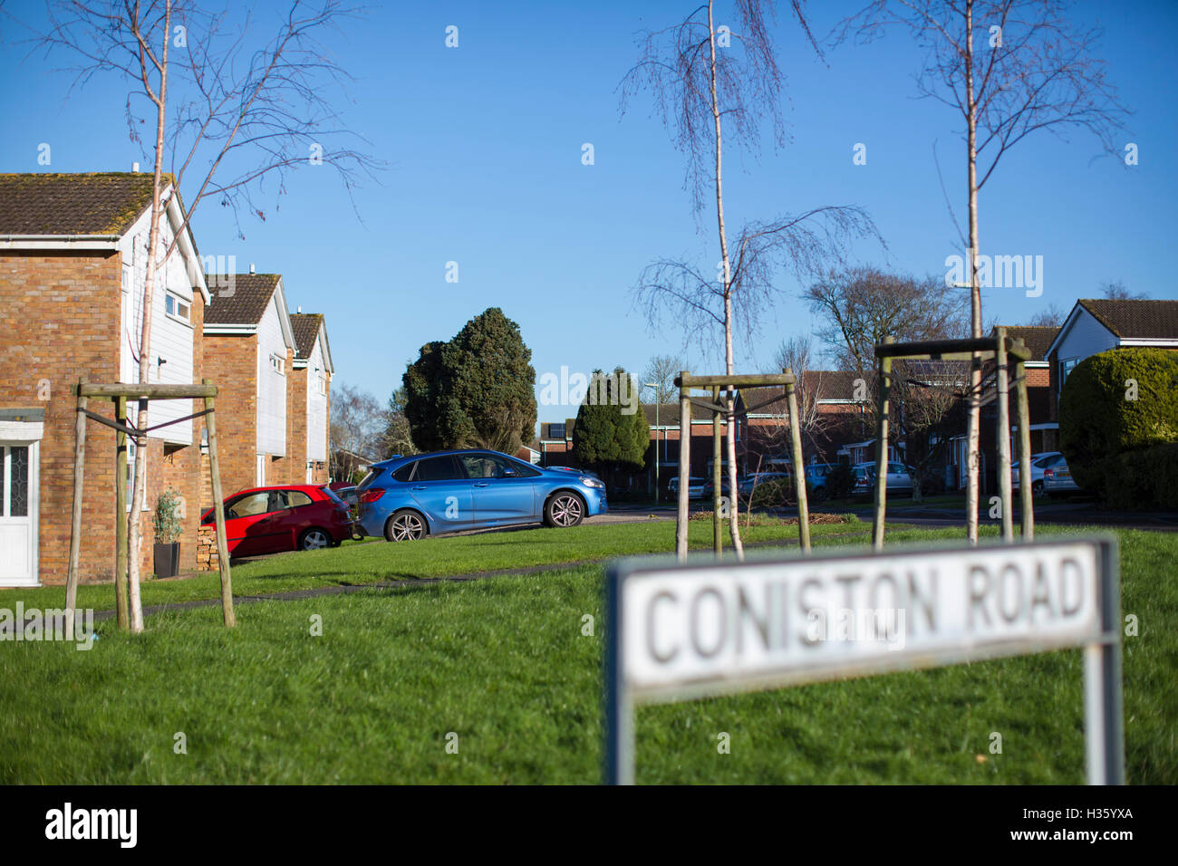 Housing estate in Basingstoke, Hampshire, UK with houses, trees and street furniture. Stock Photo