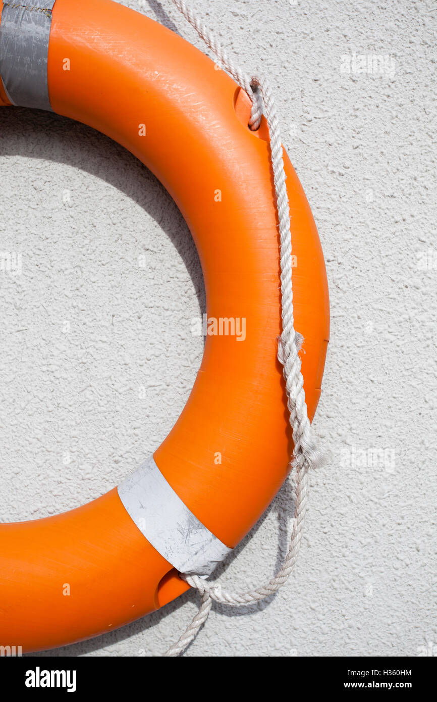Swimmers rescue float ring hanging o na wall near a swimming pool Stock