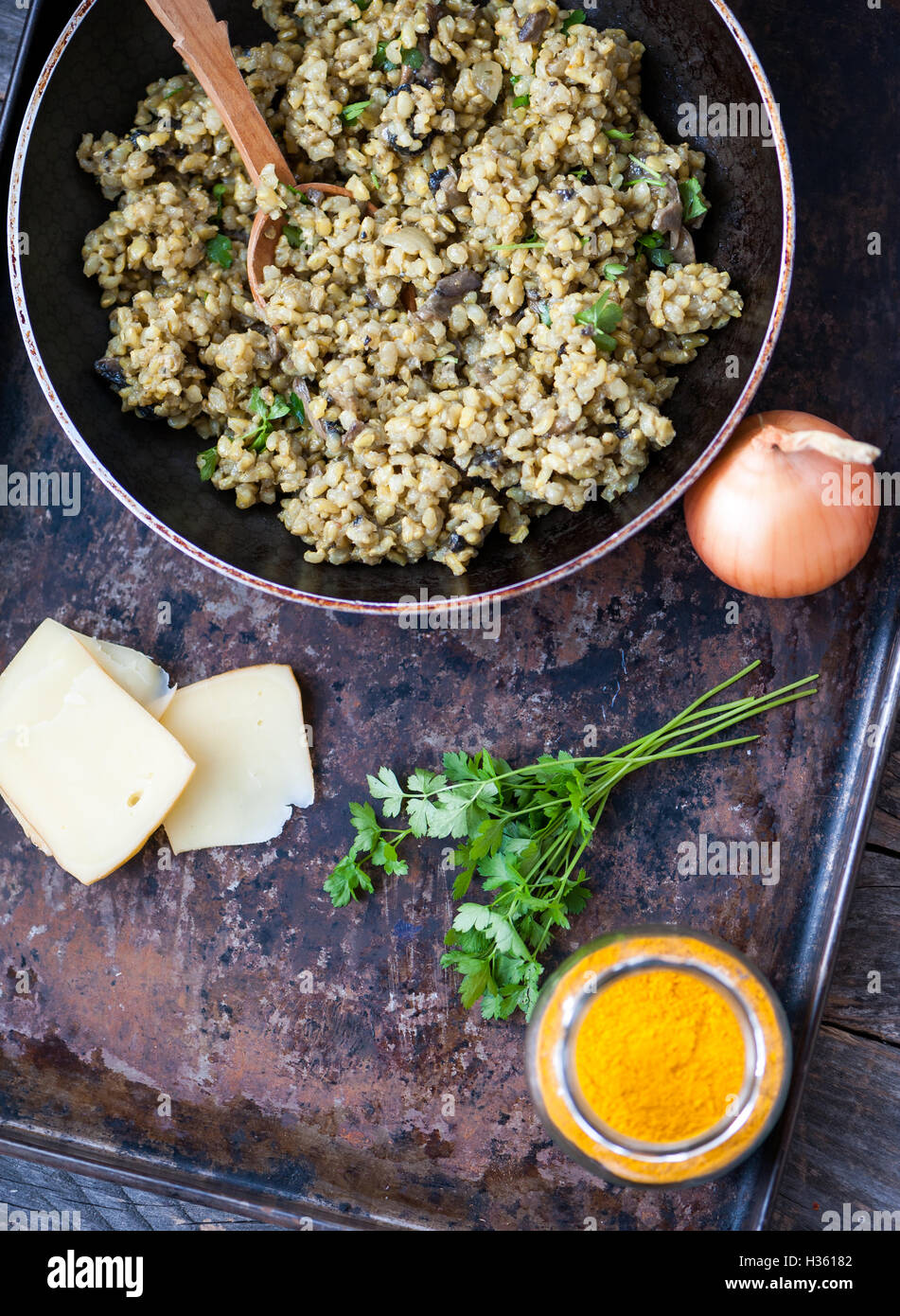 Mushroom risotto with brown rice, parsley and turmeric Stock Photo Alamy