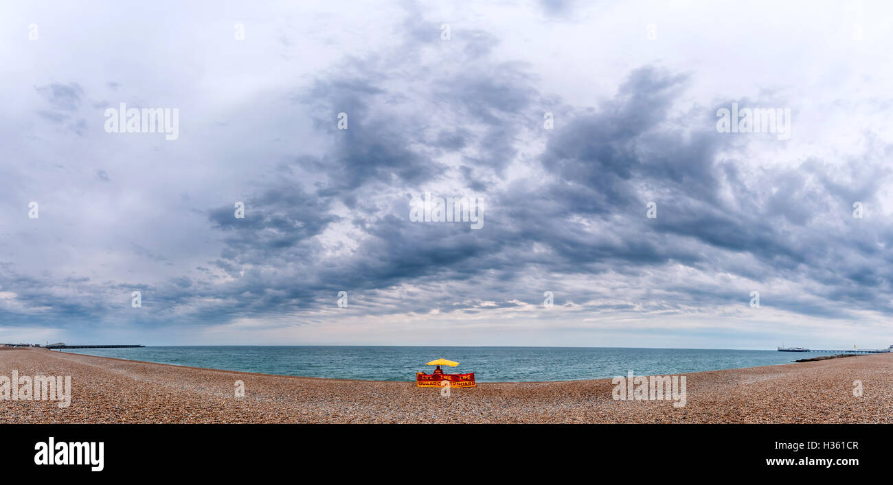 Lifeguards facing a lonely day on Brighton beach, after a turn in the weather. N.B. THIS PHOTOGRAPH IS A PHOTOMERGE Stock Photo