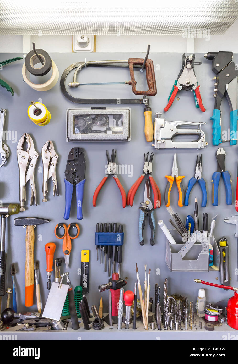 Work Tools Hanging On Wall In Workshop Or Garage Stock Photo