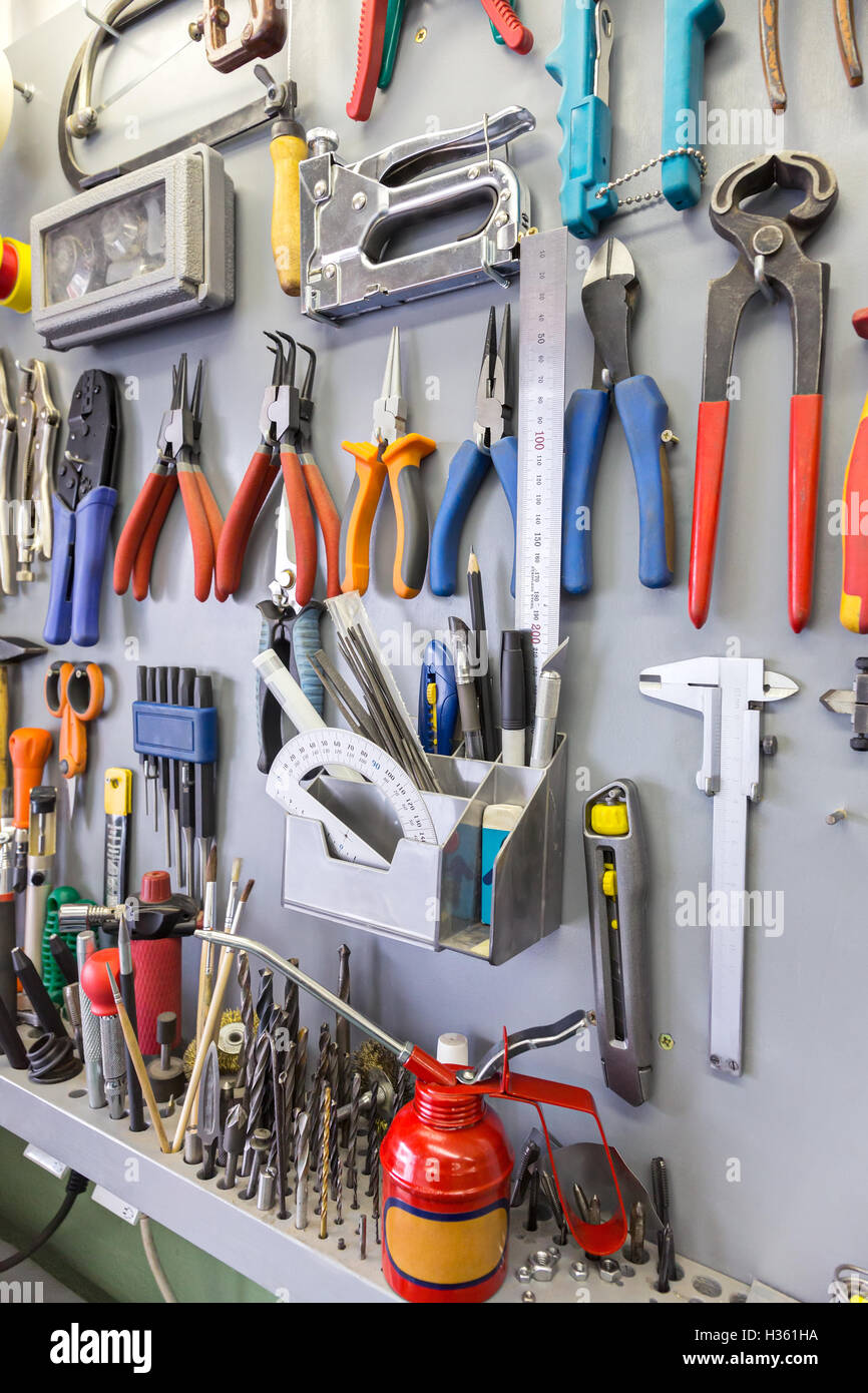 Work Tools Hanging On Wall In Workshop Or Garage Stock Photo