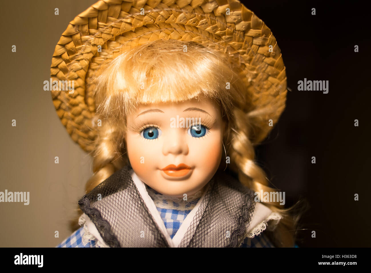 Blonde doll with straw hat Stock Photo