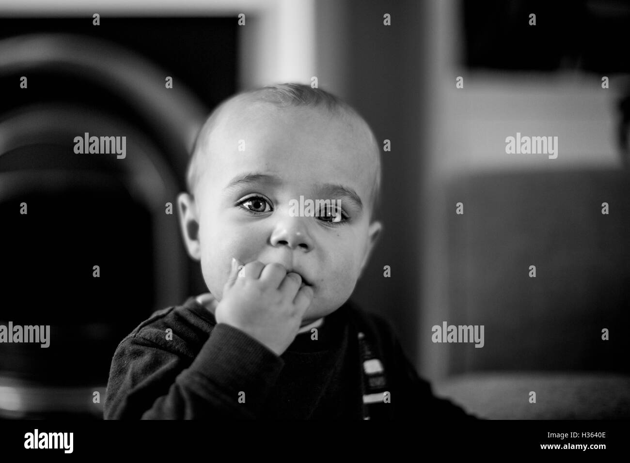 Little boy chewing his fingers to soothe his teeth Stock Photo Alamy