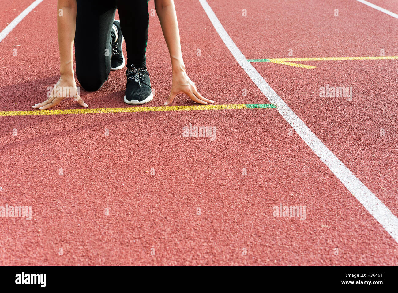 Female Hands on starting line waiting for the start in running track, workout session Stock Photo