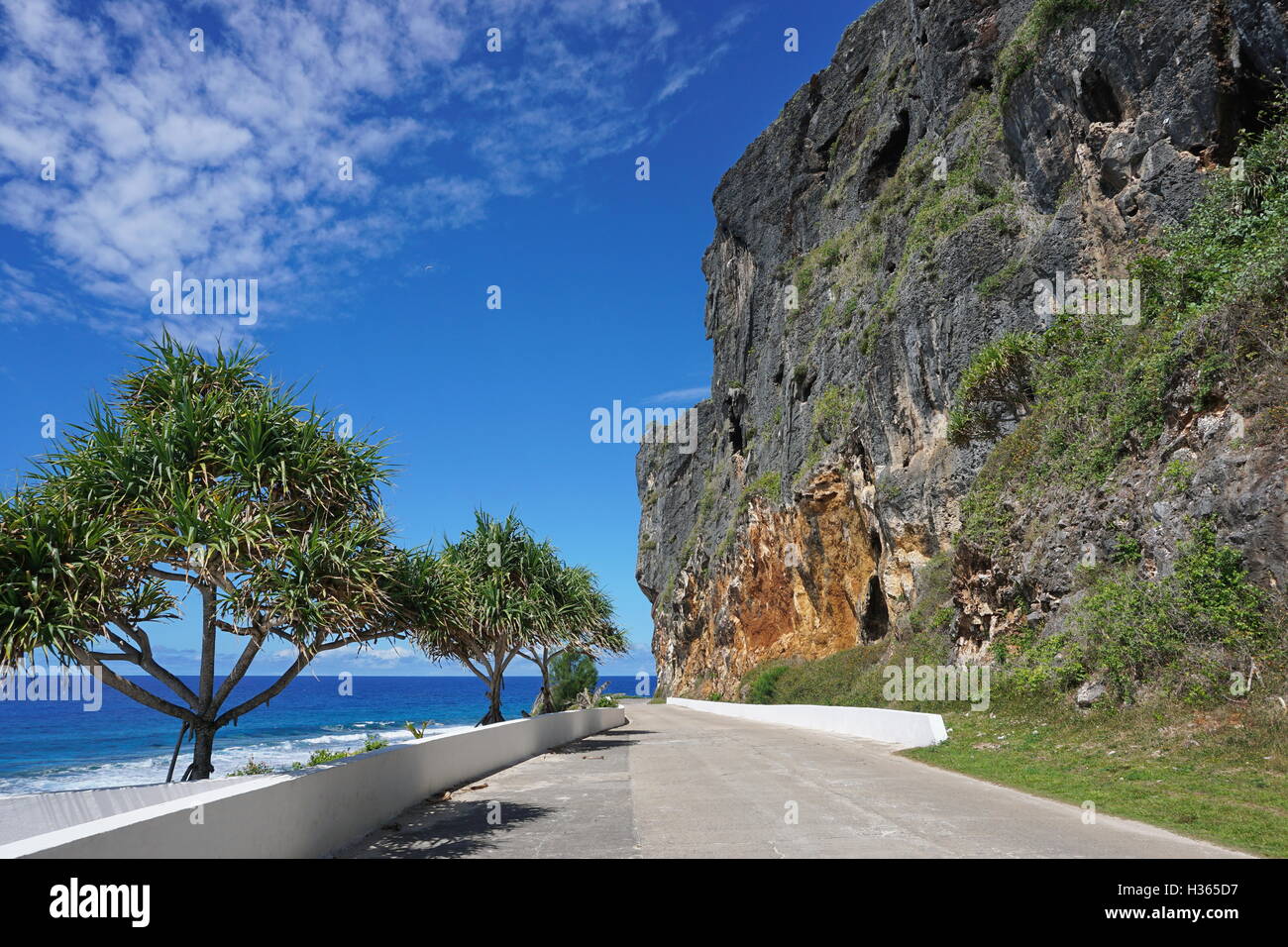 Eroded limestone cliff along the coastal road of Rurutu island, Pacific ocean, Austral archipelago, French Polynesia Stock Photo