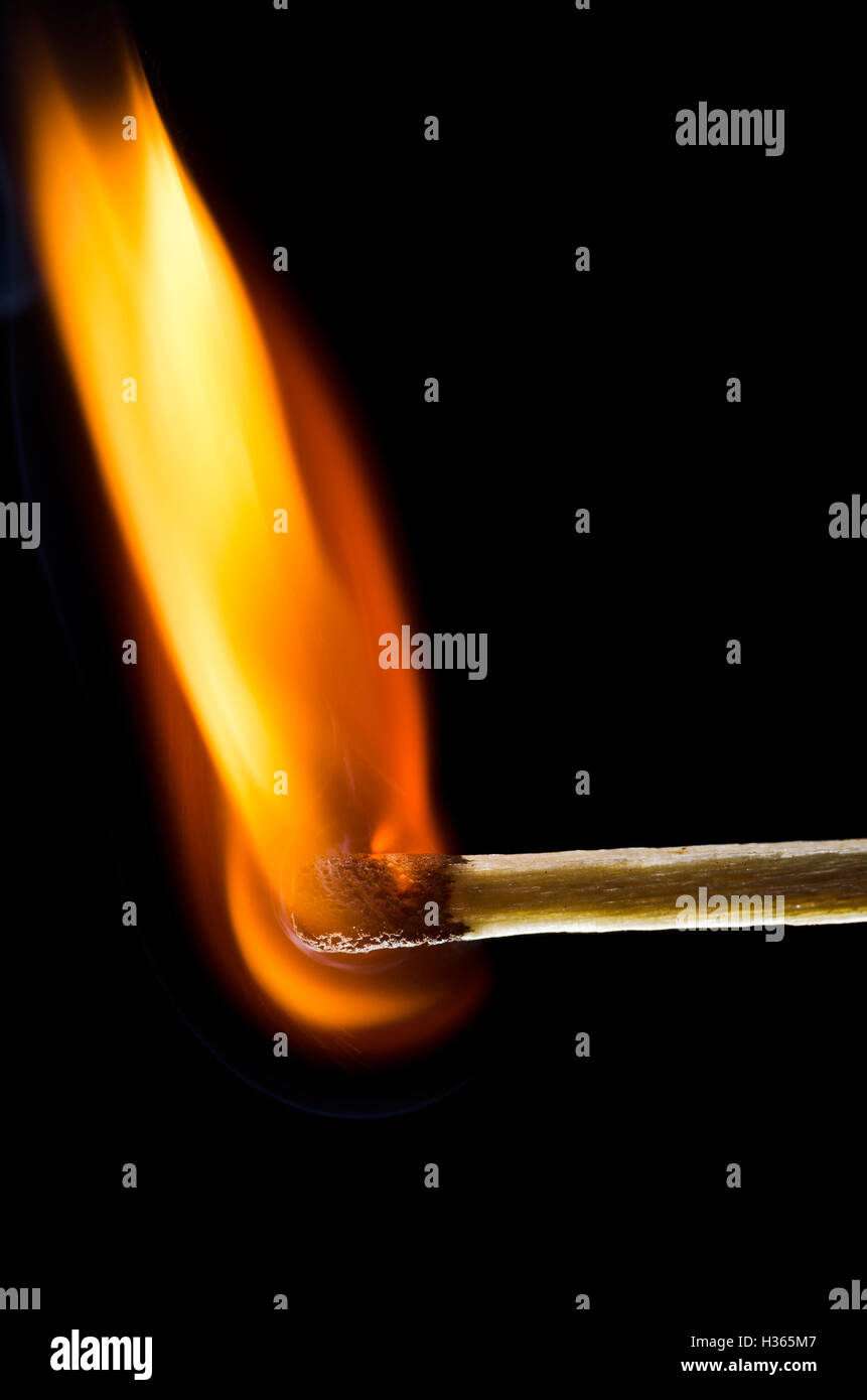 Matchstick burning isolated on black background Stock Photo