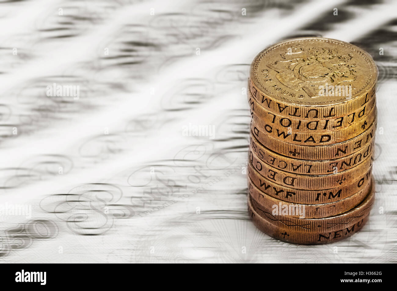 Sterling pound depreciation devaluation reduction value concept closeup macro view at UK currency stack of one pound coins Stock Photo