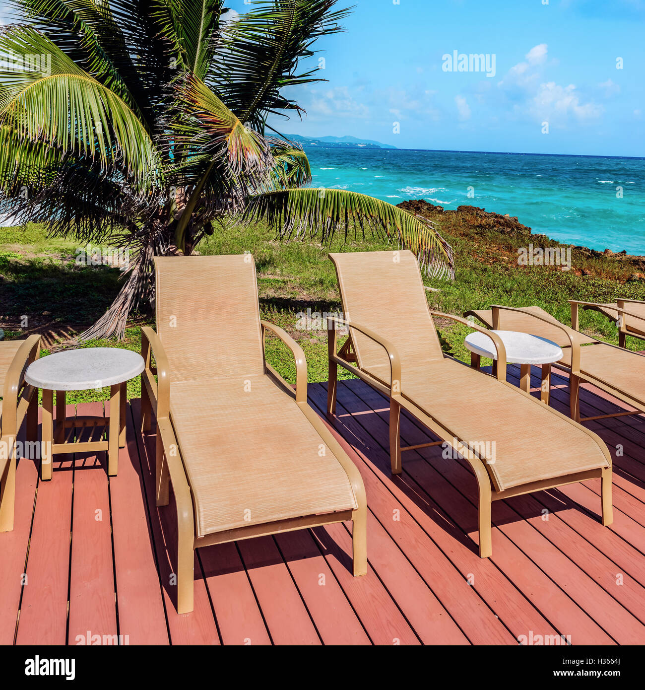 Loungers on the deck by the seafront Tobago Caribbean square composition Stock Photo