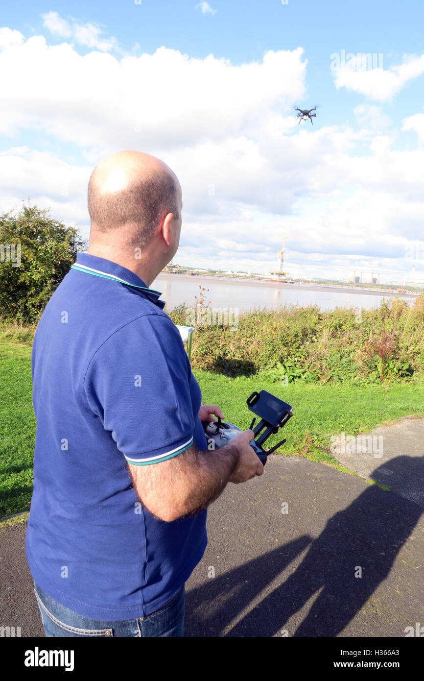 Man flying 3DR RTF X8 drone near River Mersey, Merseyside, England Stock Photo