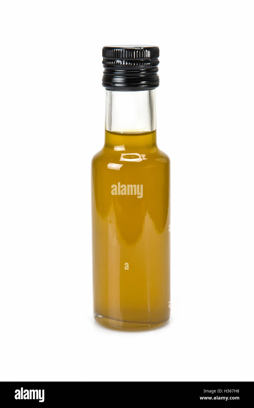 Glass bottle of premium virgin olive oil and some olives with leaves ...