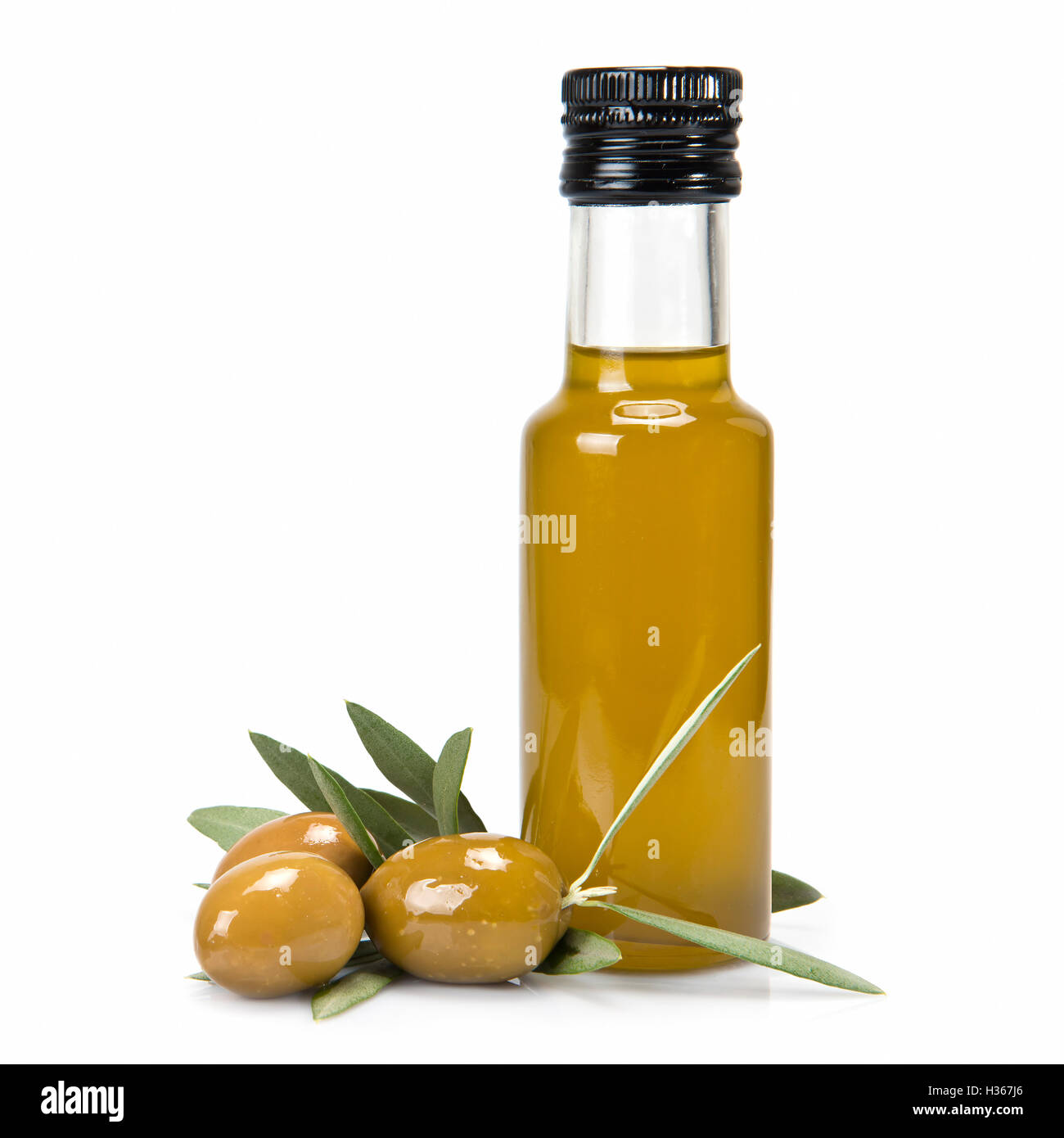 Glass bottle of premium virgin olive oil and some olives with leaves ...