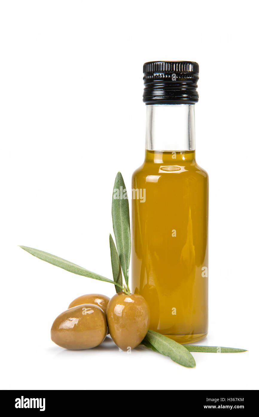 Glass bottle of premium virgin olive oil and some olives with leaves ...