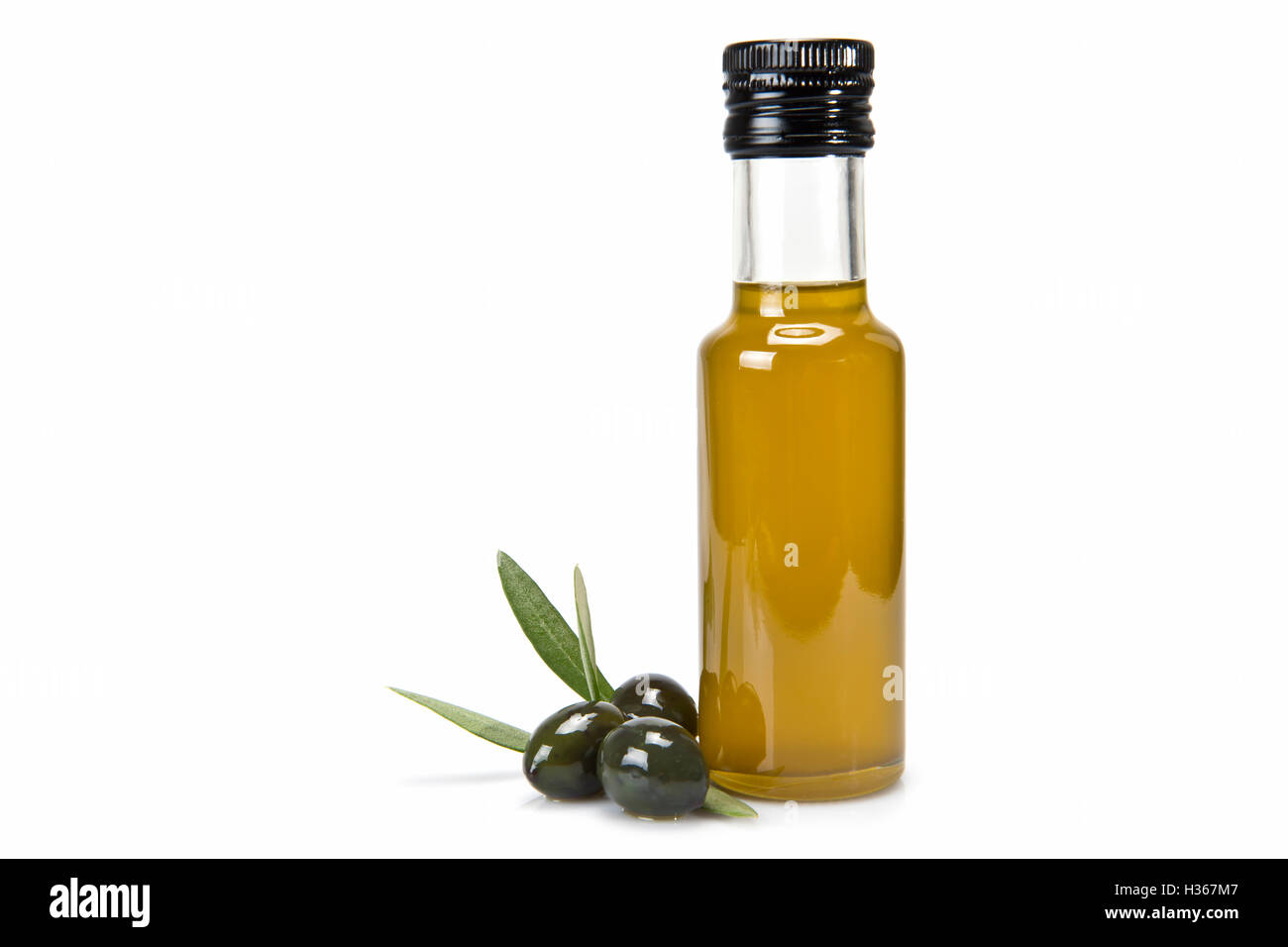 Glass bottle of premium virgin olive oil and some olives with leaves ...
