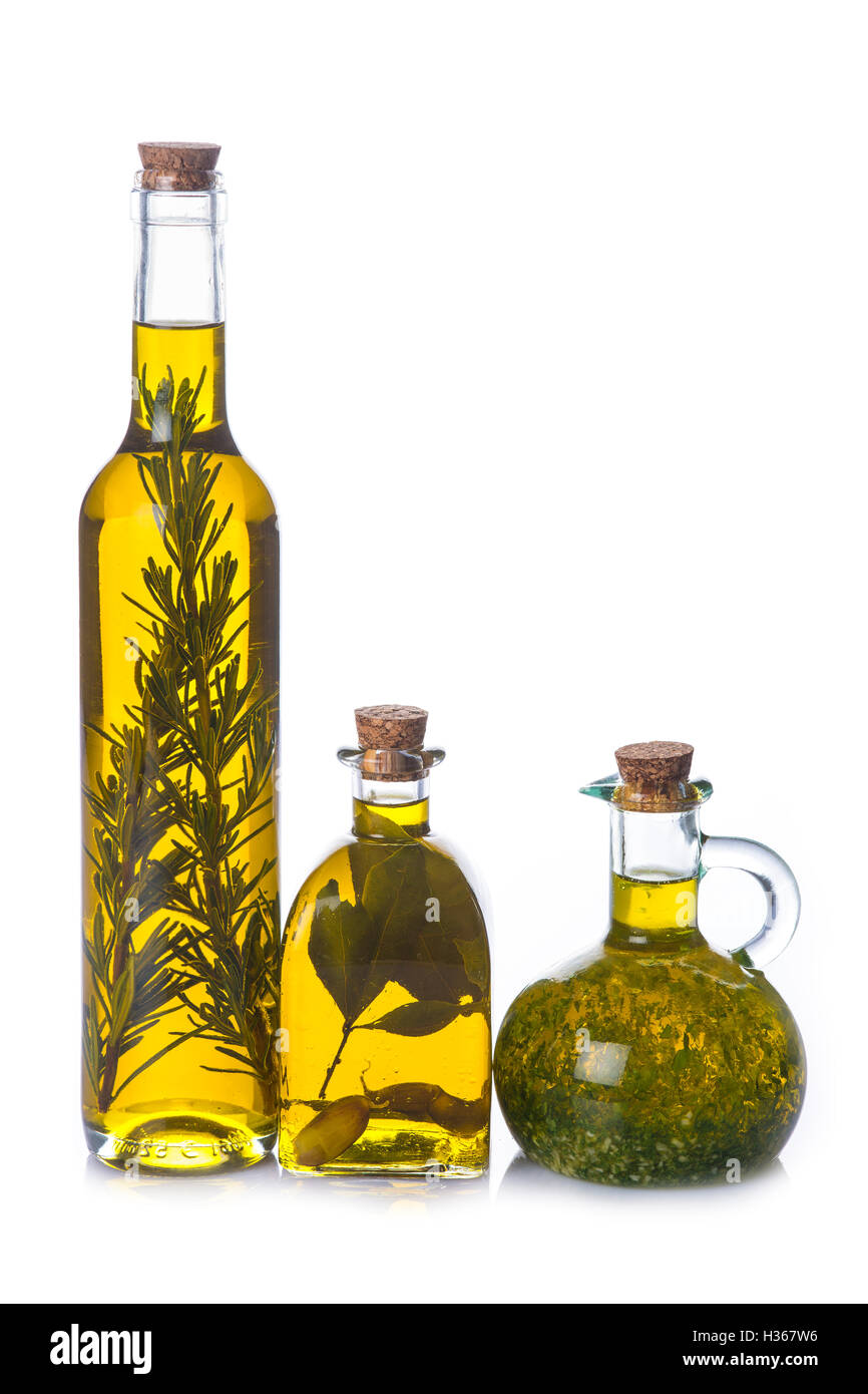 Olive oil bottles with aromatic herbs isolated on a white background