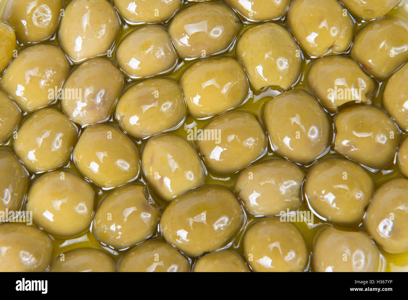 Texture of pitted olives covered in olive oil and ready to eat Stock