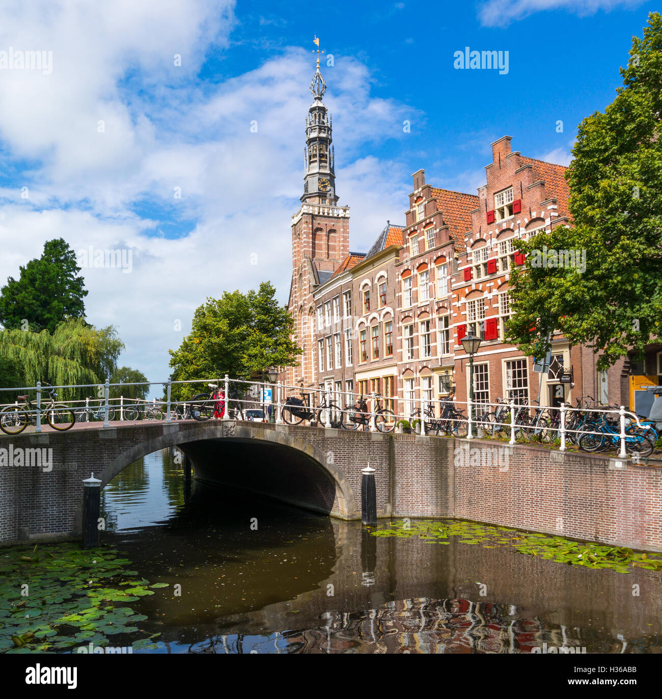 Groenebrug bridge over Steenschuur canal, Louis church tower and gables of old houses in downtown Leiden, South Holland, Netherl Stock Photo