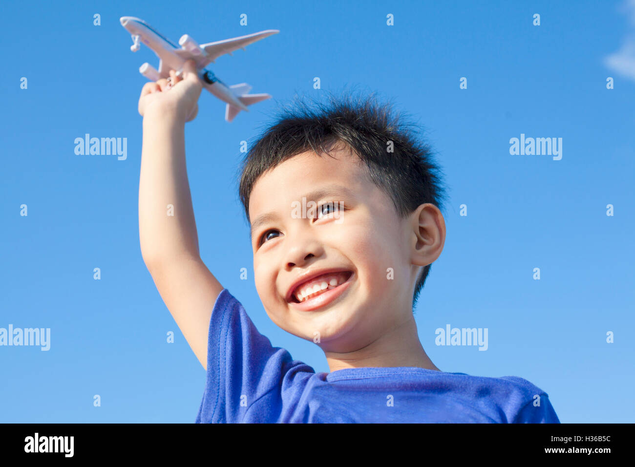 happy boy playing a airplane toy with blue sky background Stock Photo ...