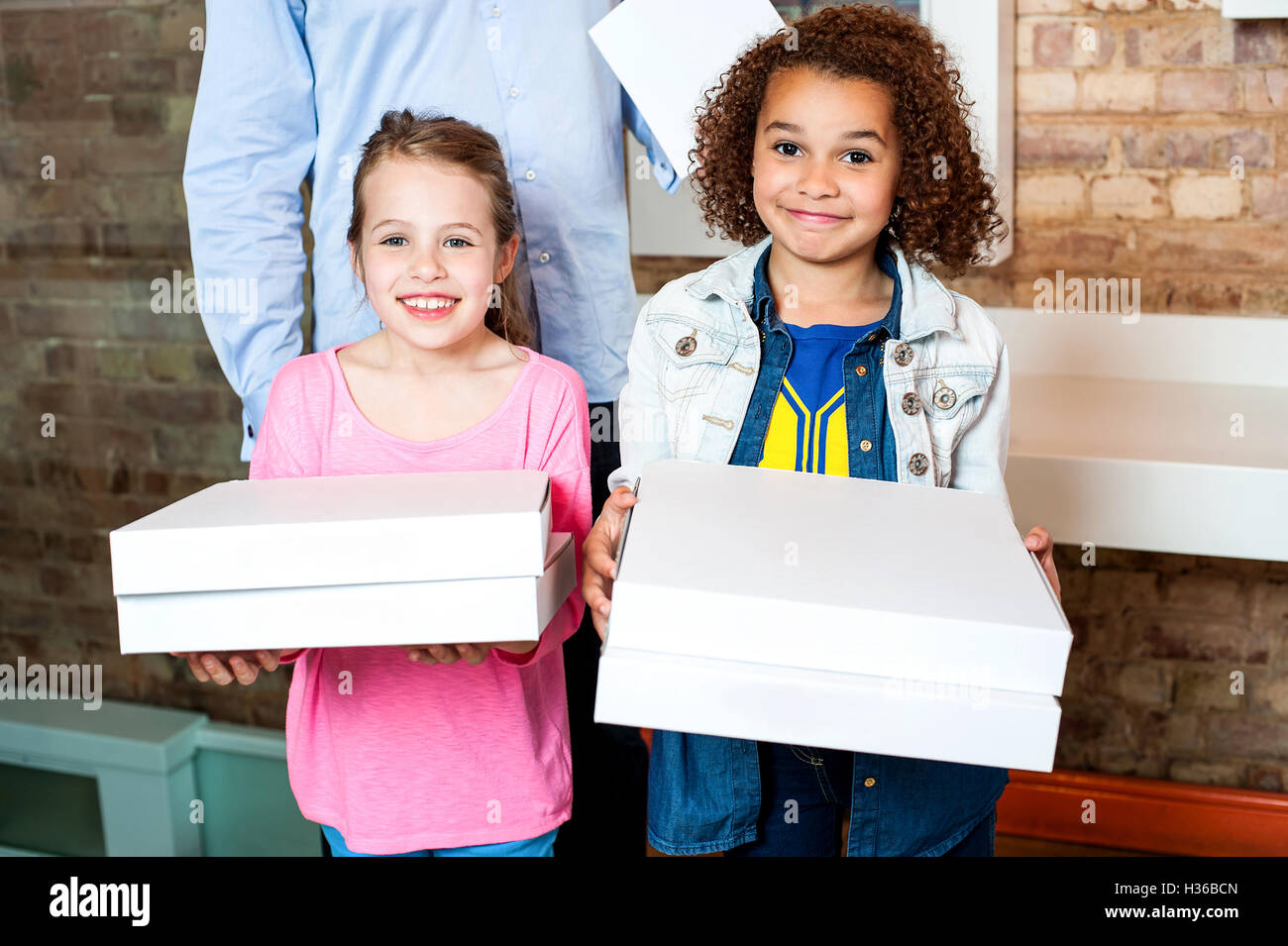 Kids holding pizza boxes Stock Photo - Alamy