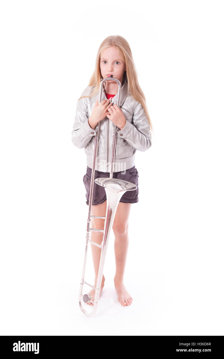 young girl in silver jacket standing with her trombone Stock Photo