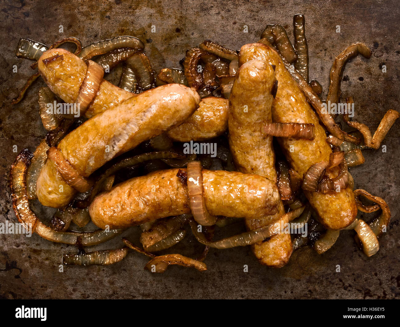 rustic sausages with caramelised onions Stock Photo