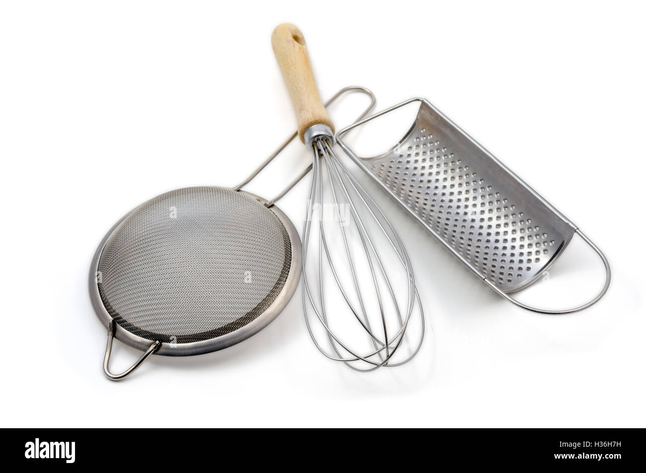 whisk, strainer and grater isolated over white Stock Photo