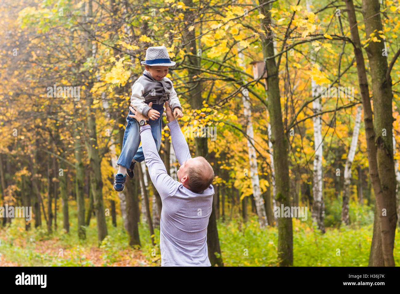 Father and son playing in a beautiful autumn park Stock Photo - Alamy