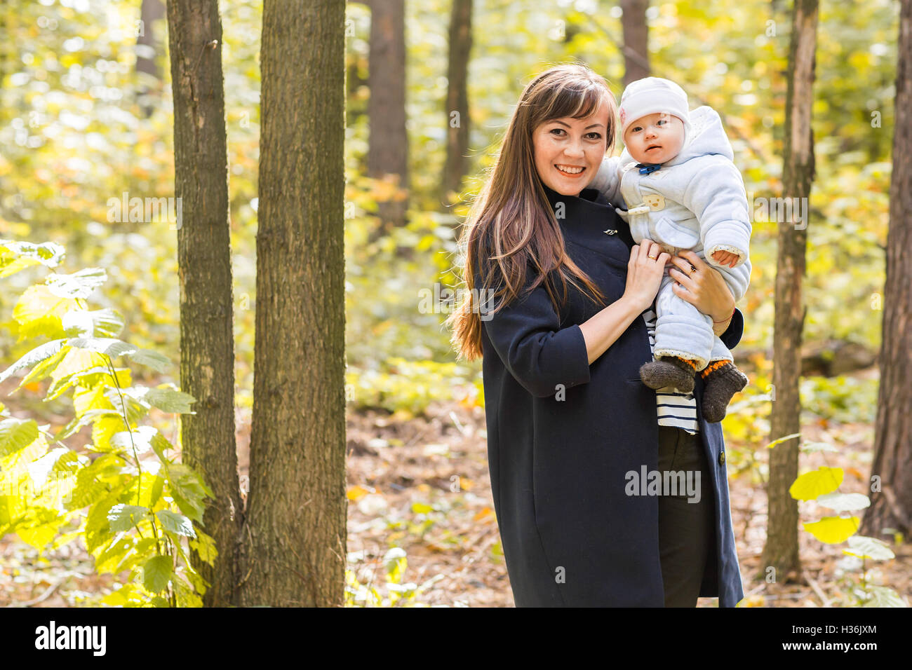 Mother and baby daughter in the autumn park Stock Photo - Alamy