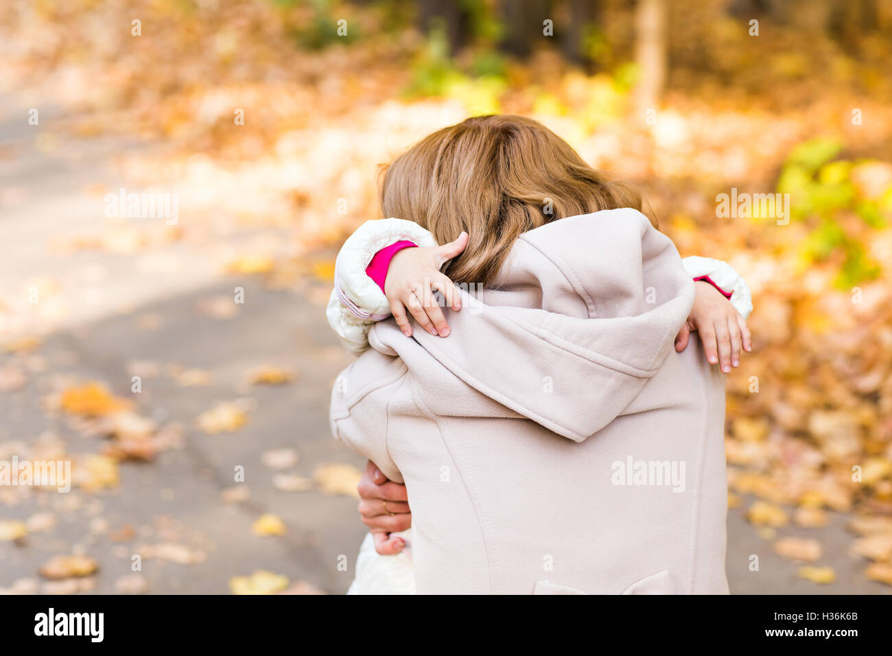 Little girl and her mother playing in the autumn park Stock Photo - Alamy