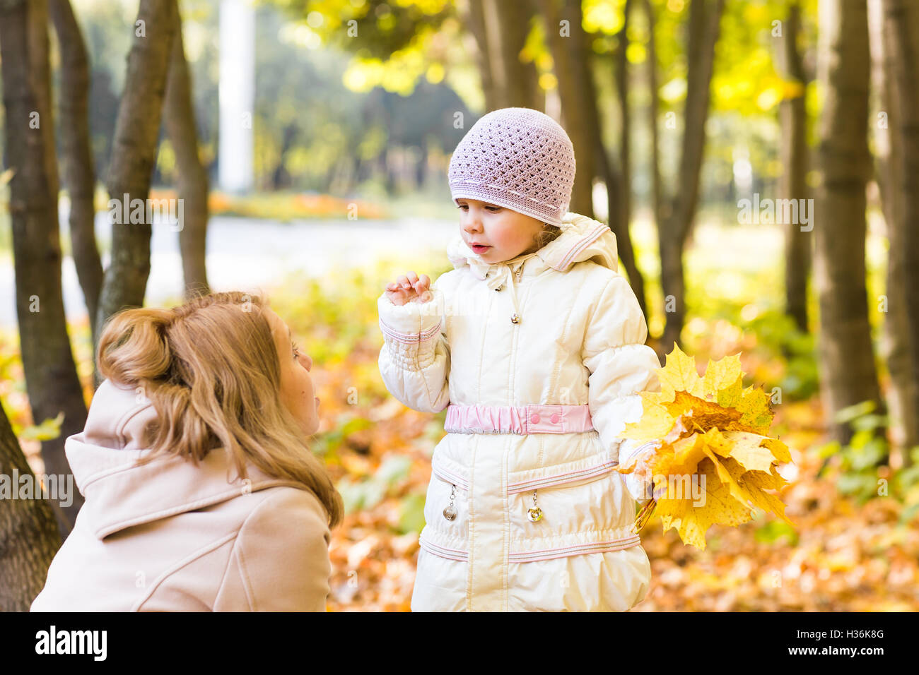 Young mother and her toddler girl have fun in autumn Stock Photo - Alamy