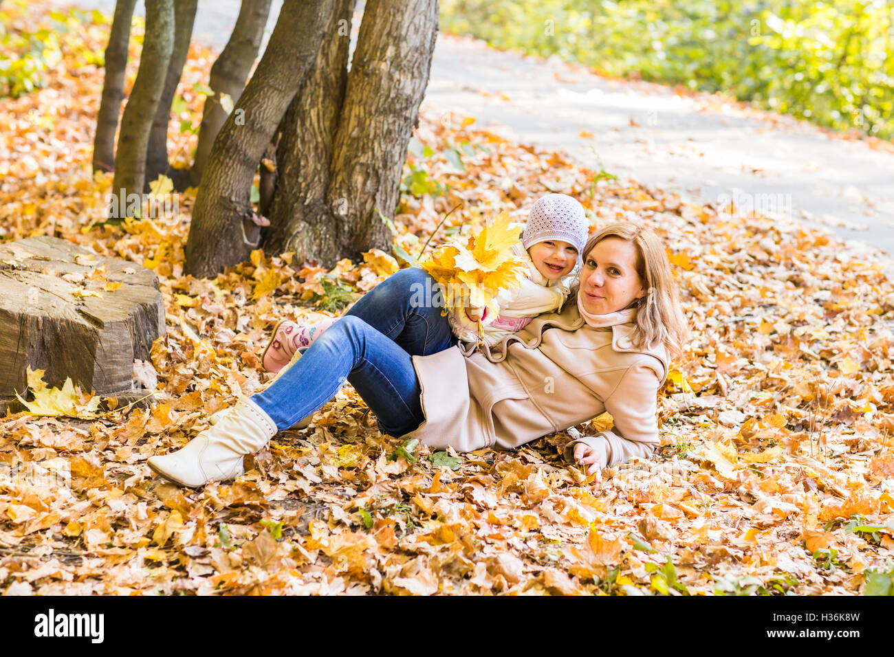 Young mother and her toddler girl have fun in autumn Stock Photo - Alamy